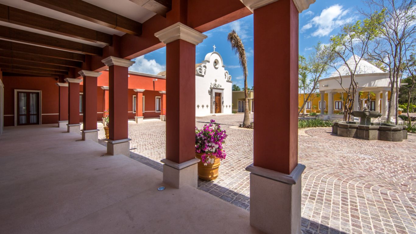 live replica of an authentic Mexican town square, with shops, chapel, fountain and plants